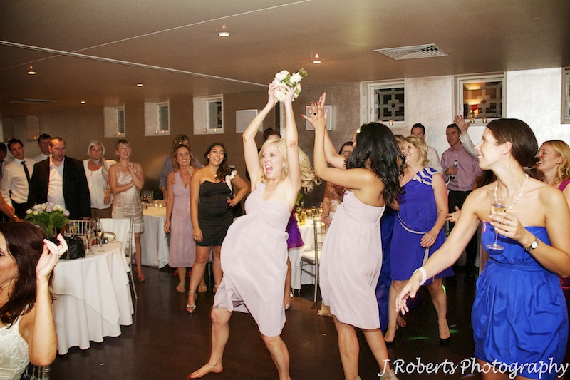 Bridesmaid catching the bouquet - wedding photography sydney